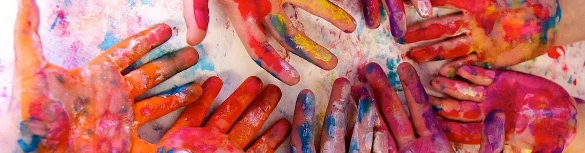 hands covered in colored paint
