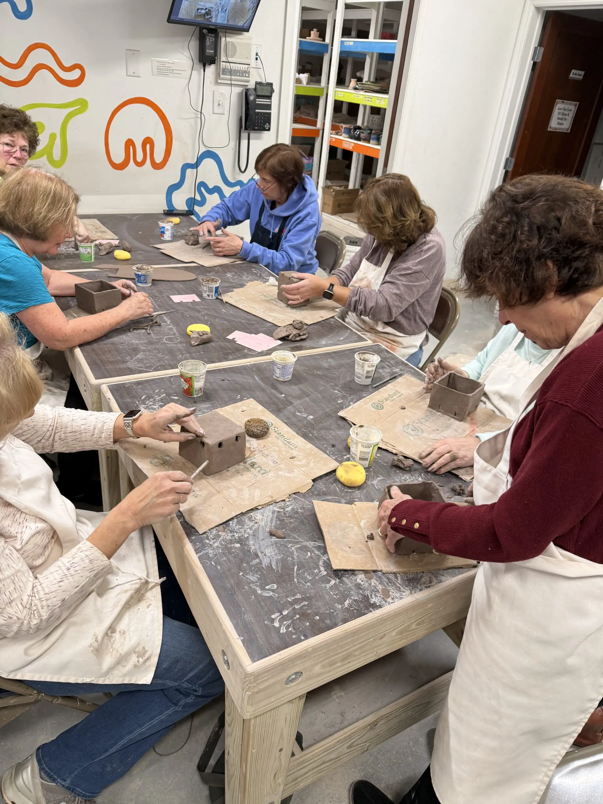 Image of adults in a class making pottery
