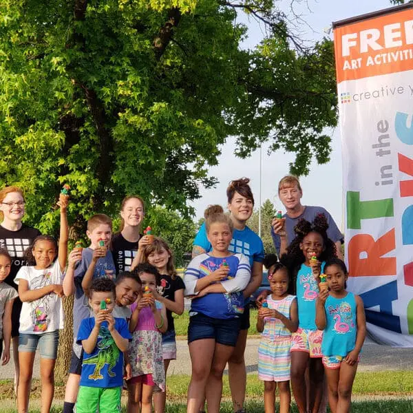 group photo of children and volunteers at art in the parks