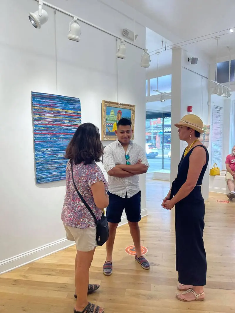 individuals talking in art gallery