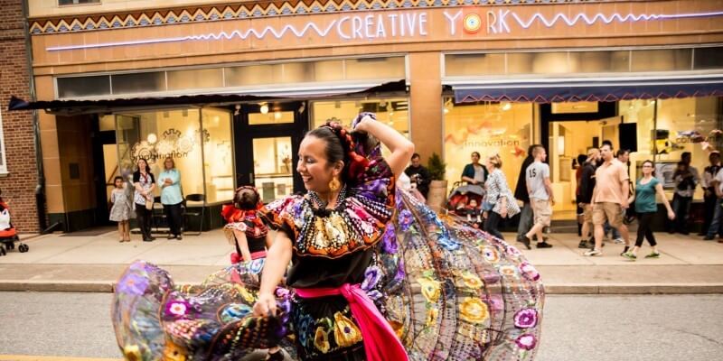 woman dancing in street in front of creative york