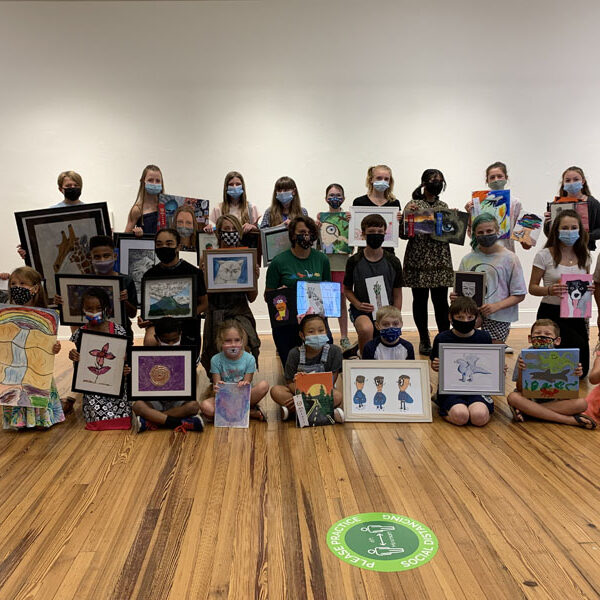children holding artwork